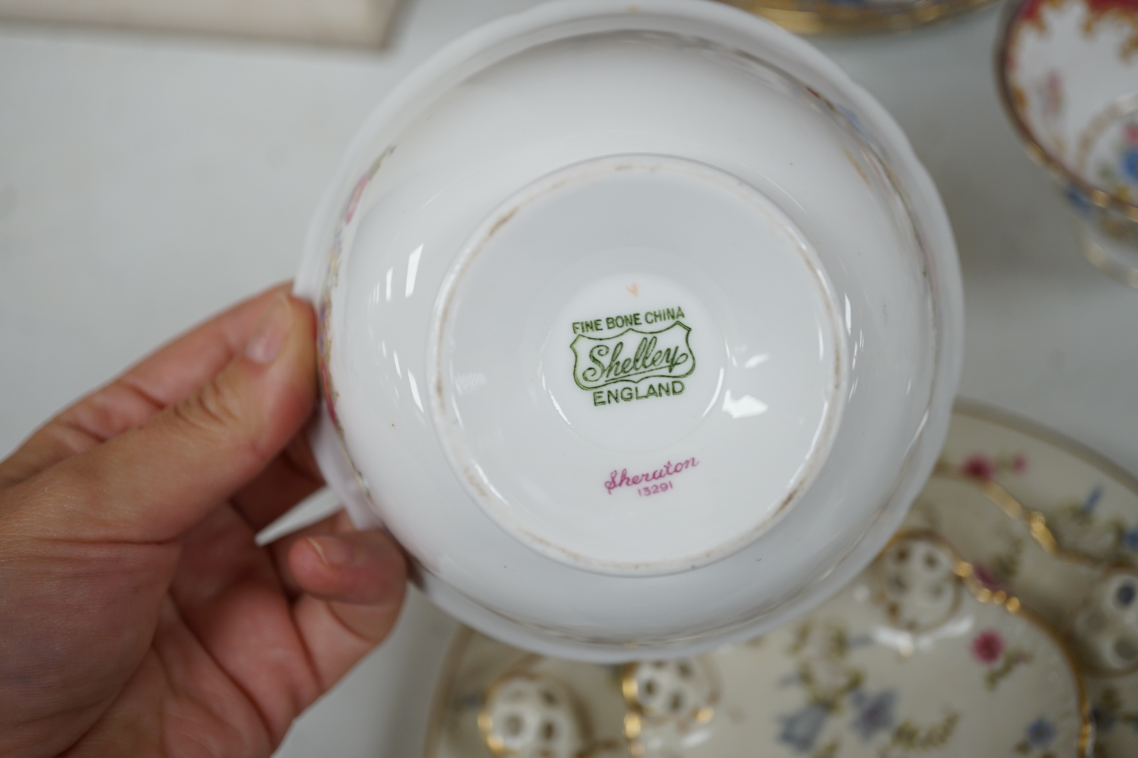 A Shelley harlequin part tea set in blue, green and pink, together with four Rosenthal dishes. Condition - good